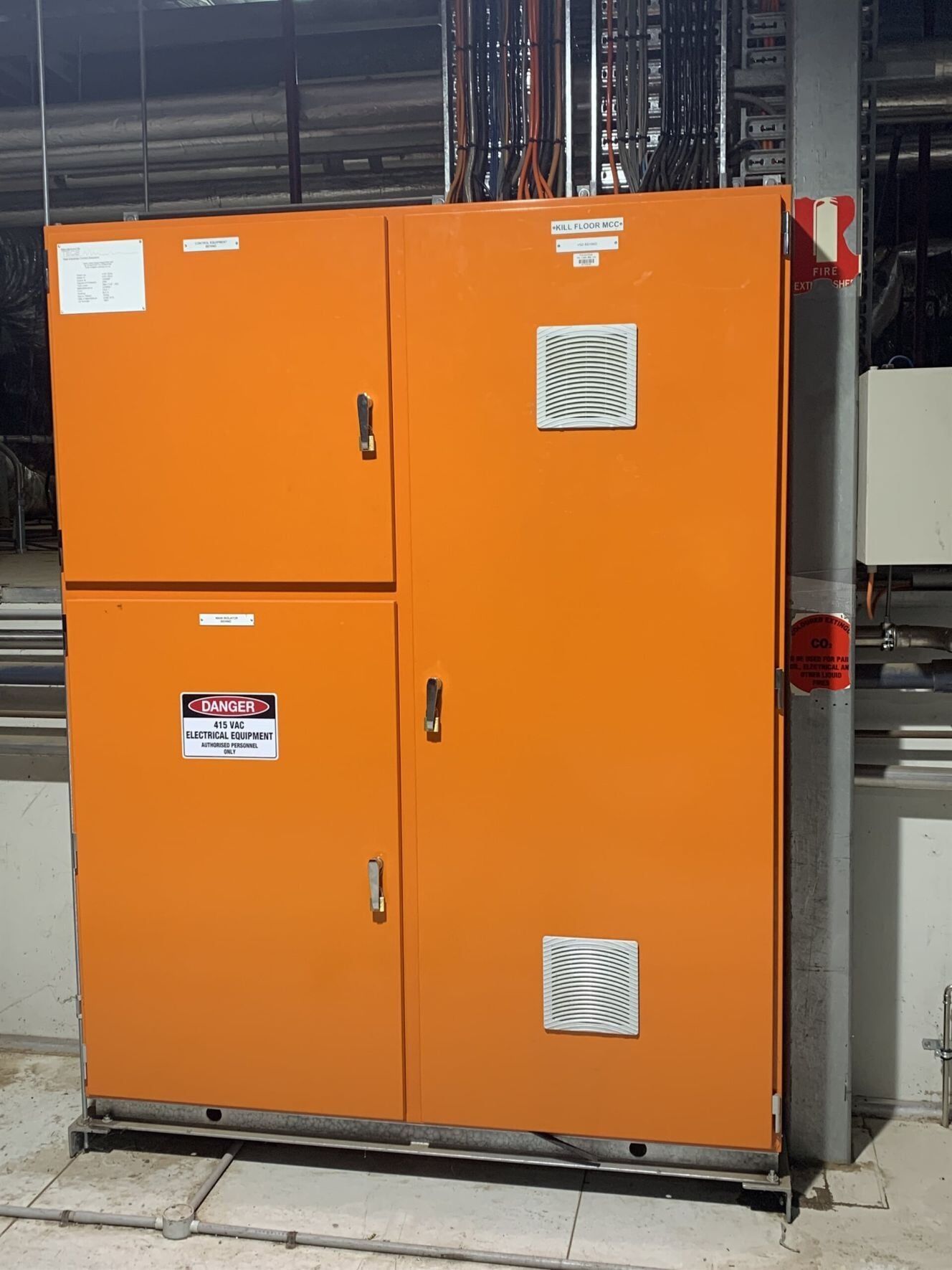 A Large Orange Cabinet with A Warning Sign on It — A & J Electrical Contractors in Taminda, NSW