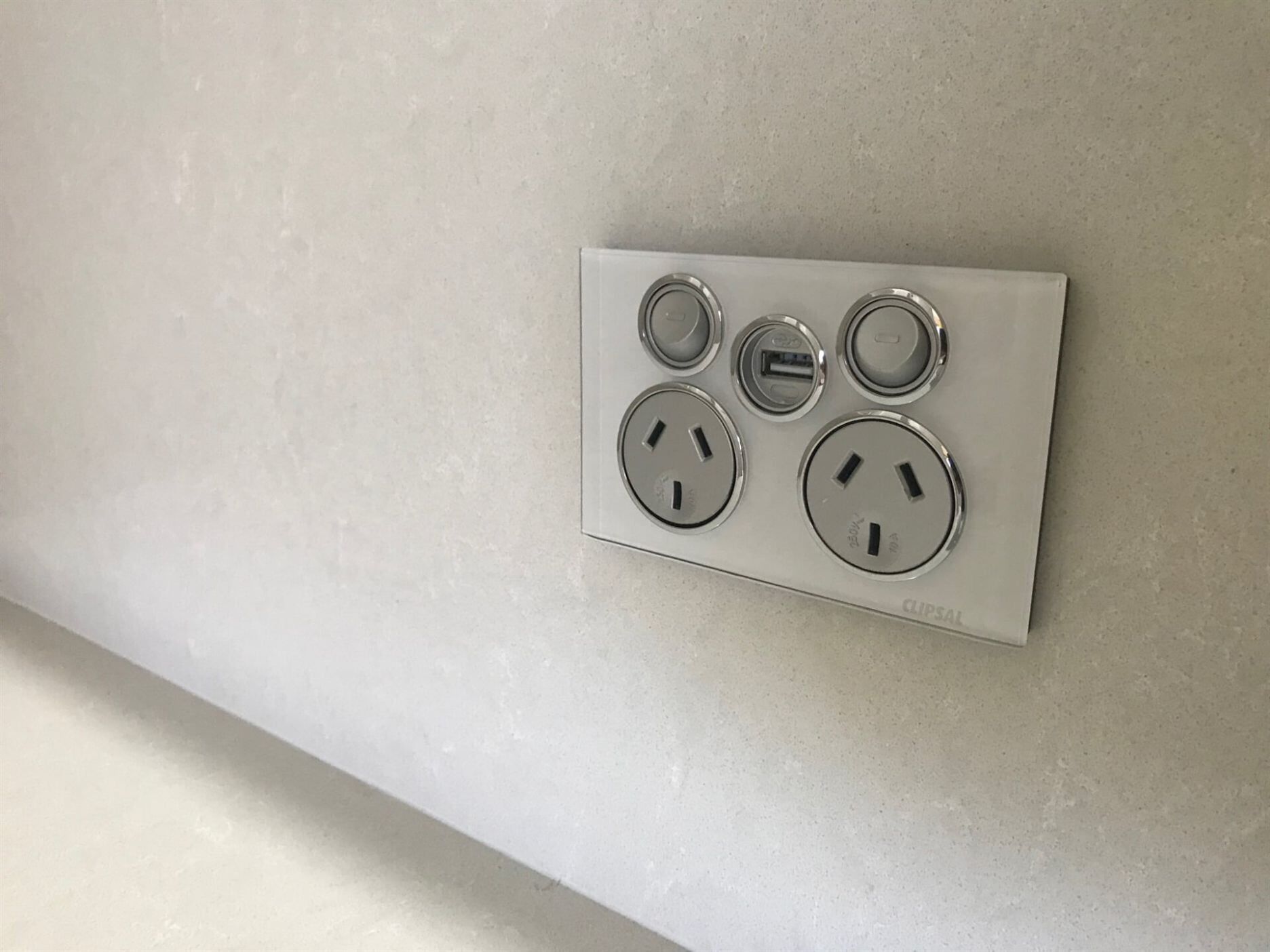 A White Electrical Outlet on A White Wall — A & J Electrical Contractors in Taminda, NSW