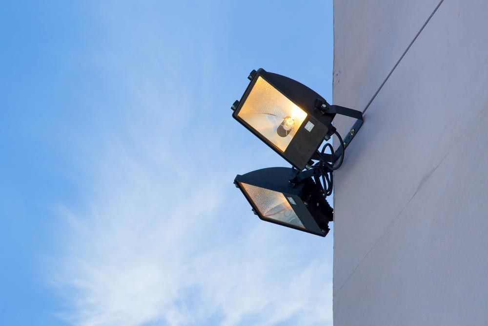 Two Street Lights Are Hanging from The Side of A Building — A & J Electrical Contractors in Taminda, NSW