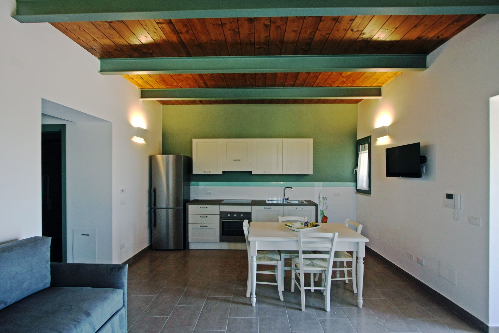 Una cucina accogliente con zona pranzo, frigorifero in acciaio inox