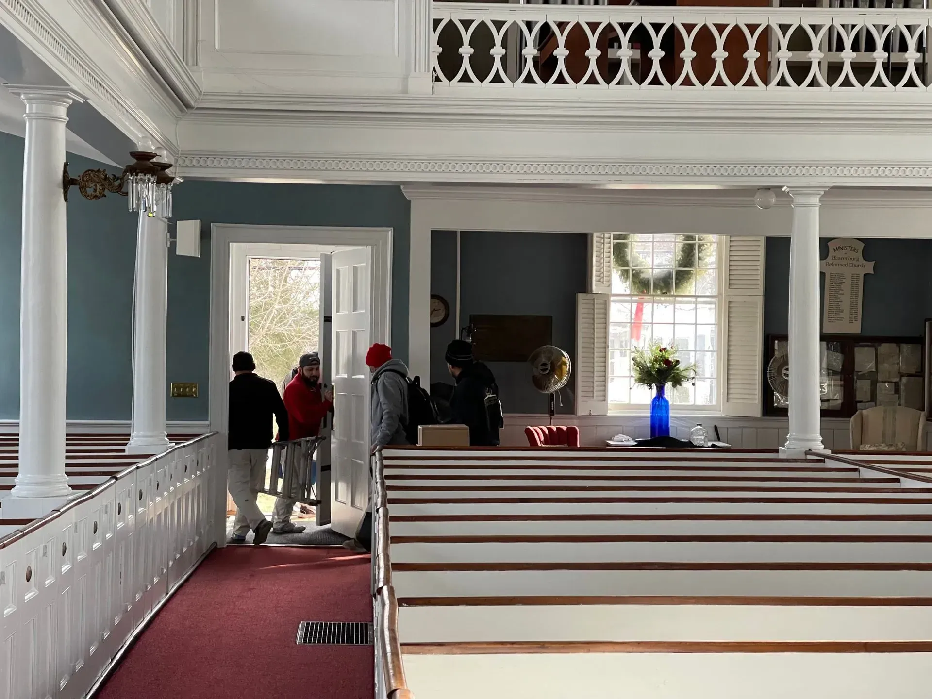 A group of people standing in an empty church