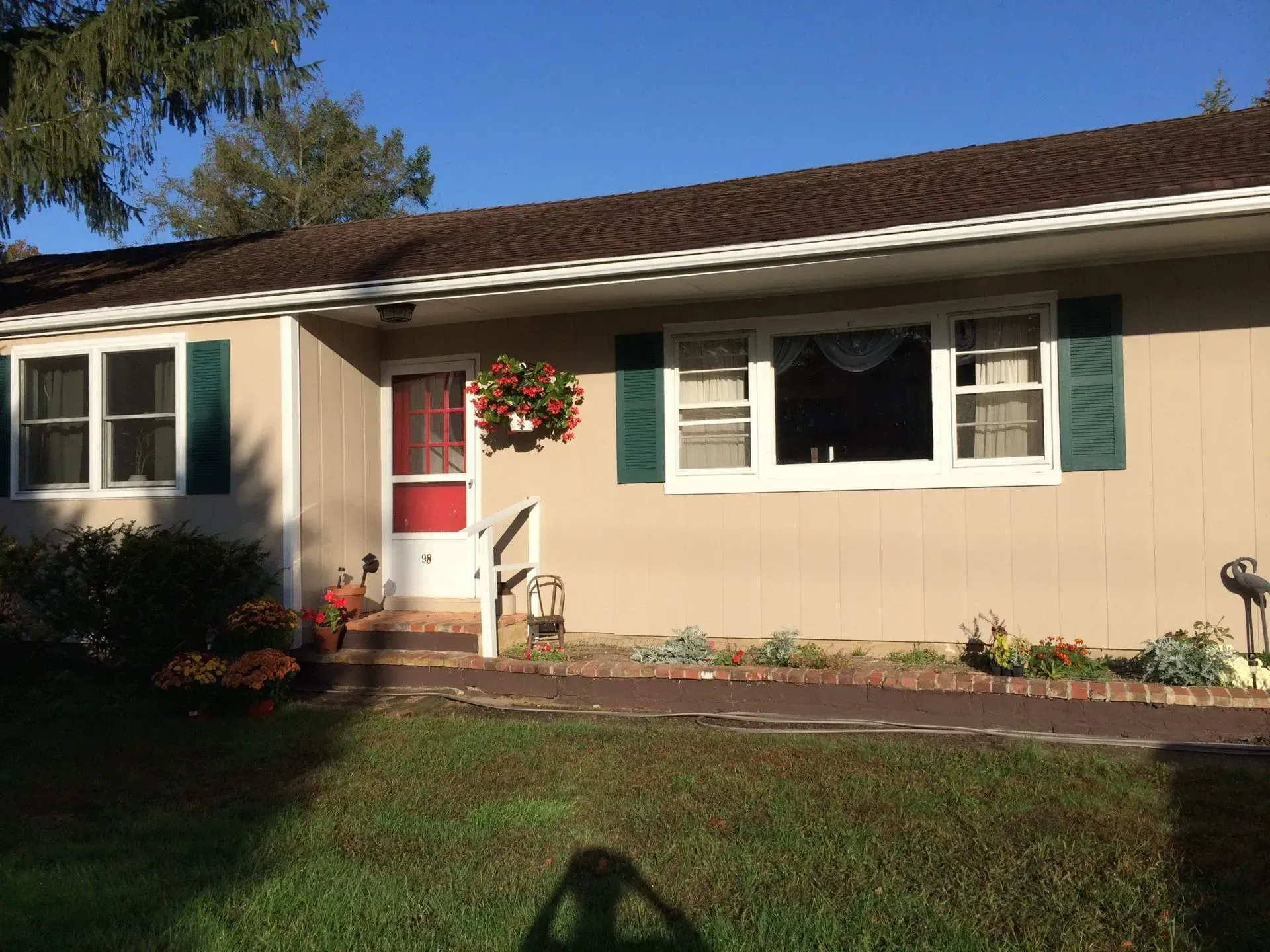 A house with green shutters and a red door