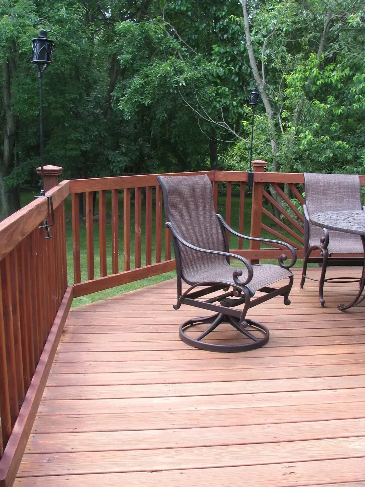 A wooden deck with a table and chairs on it