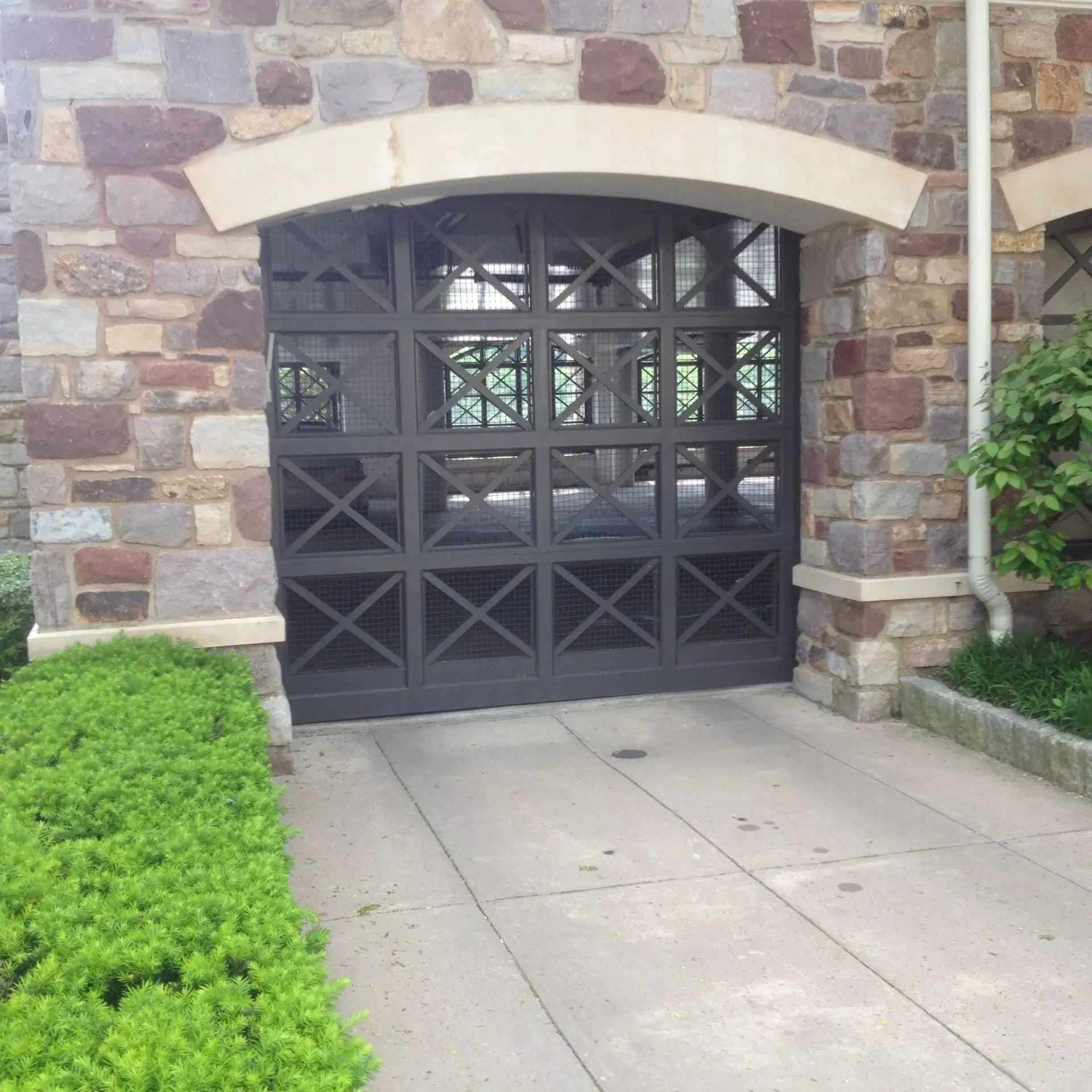 A stone building with a black garage door