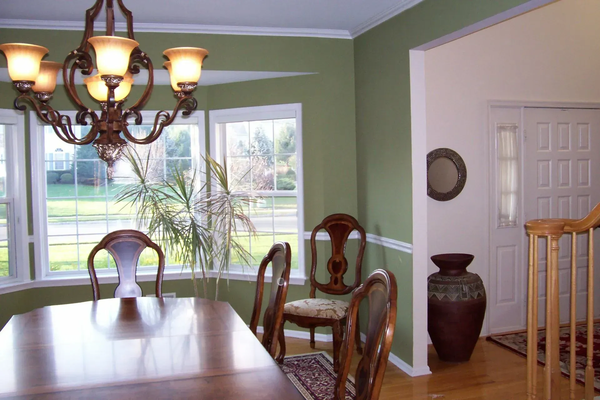 A dining room with a table and chairs and a chandelier