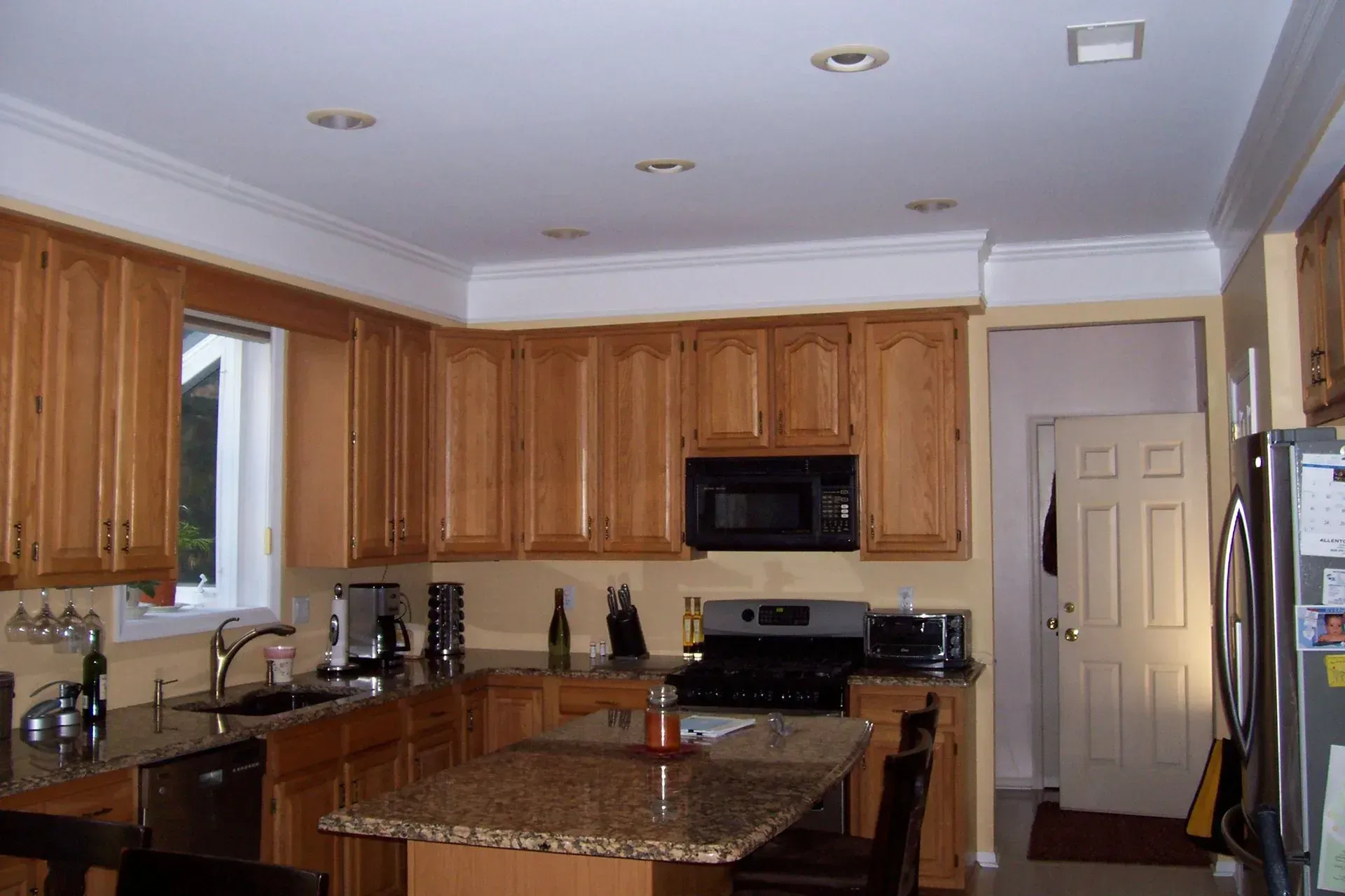 A kitchen with wooden cabinets and granite counter tops