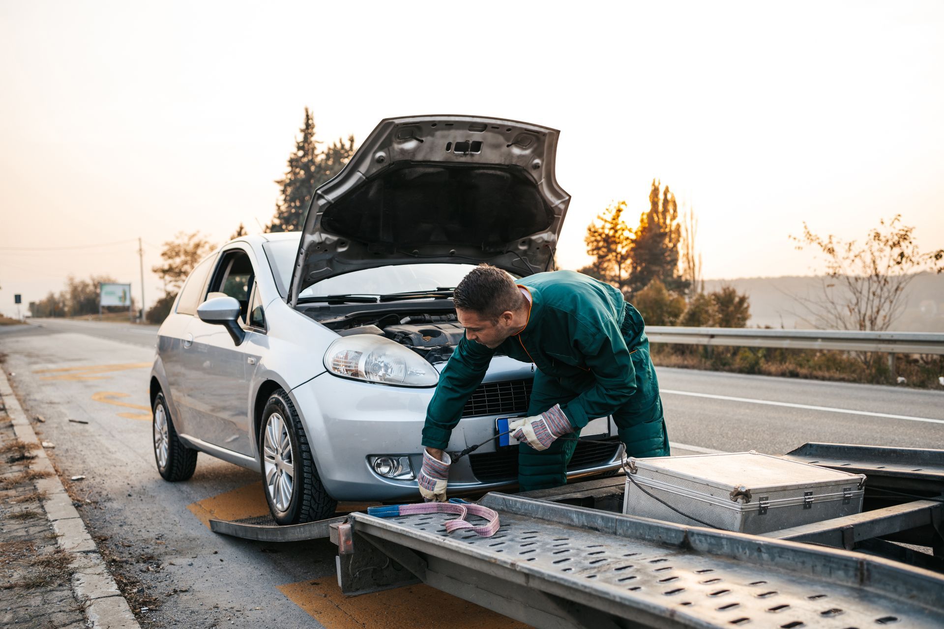 A man is towing a car.