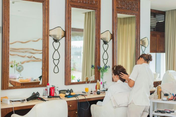 A bathroom with a large oval mirror on the wall.