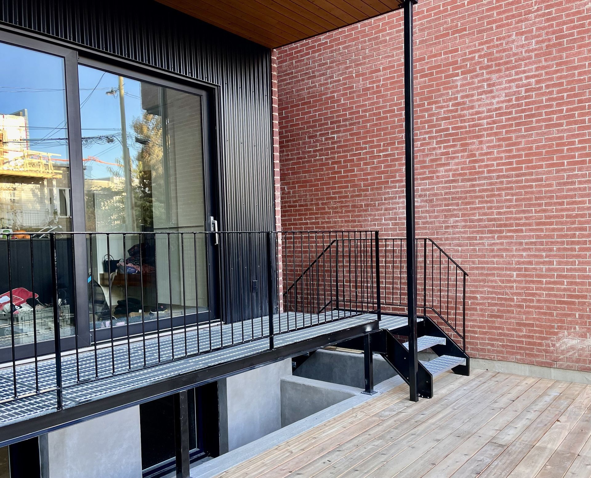 Un balcon avec escalier menant à un immeuble en brique.