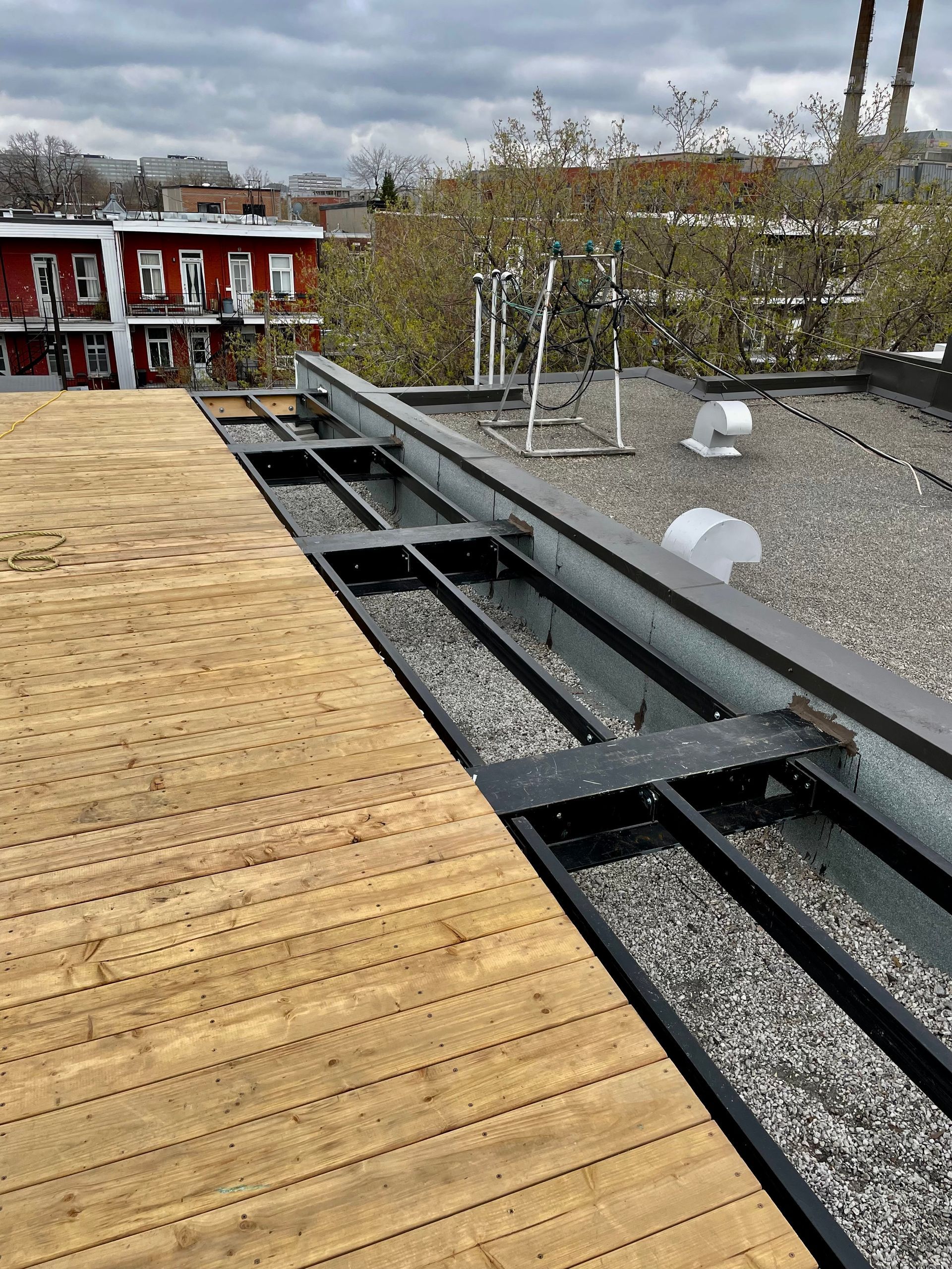 Il y a une terrasse en bois sur le toit d'un immeuble.