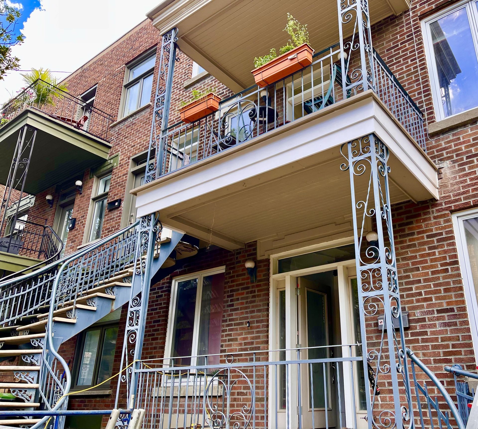 Un bâtiment en brique avec un balcon et des escaliers