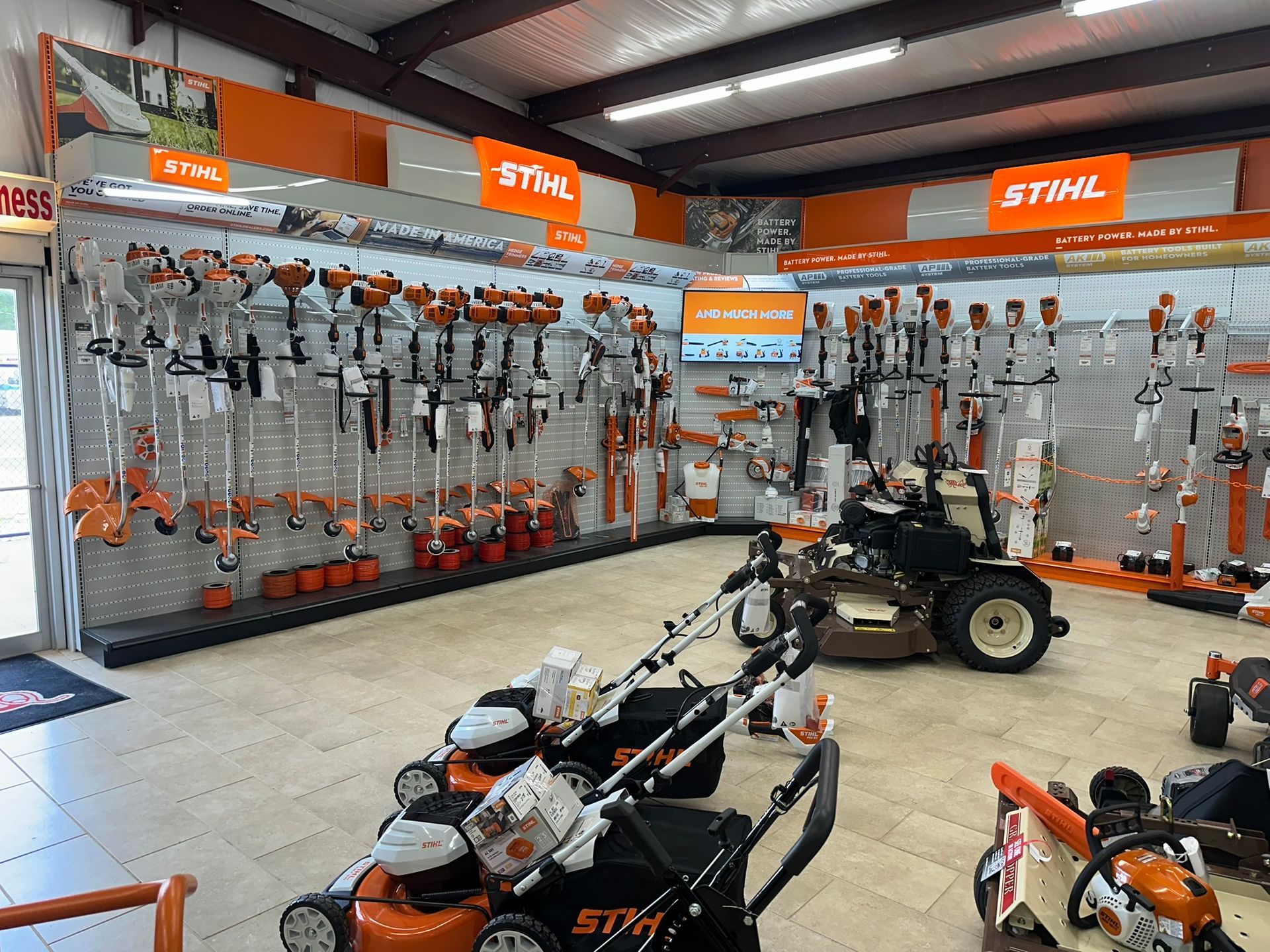 A stihl lawn mower is sitting in a store.