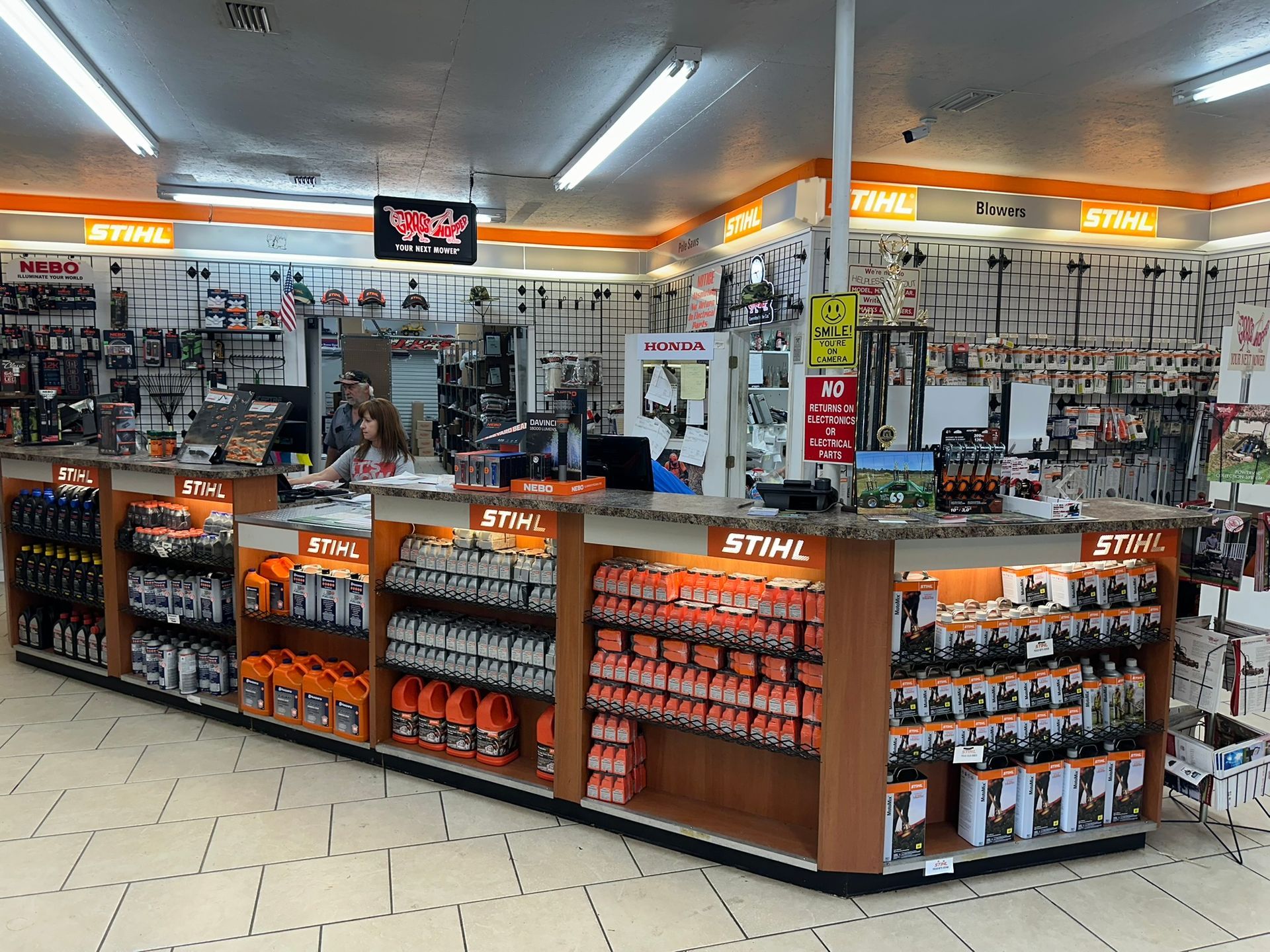 A woman is standing at a counter in a store.