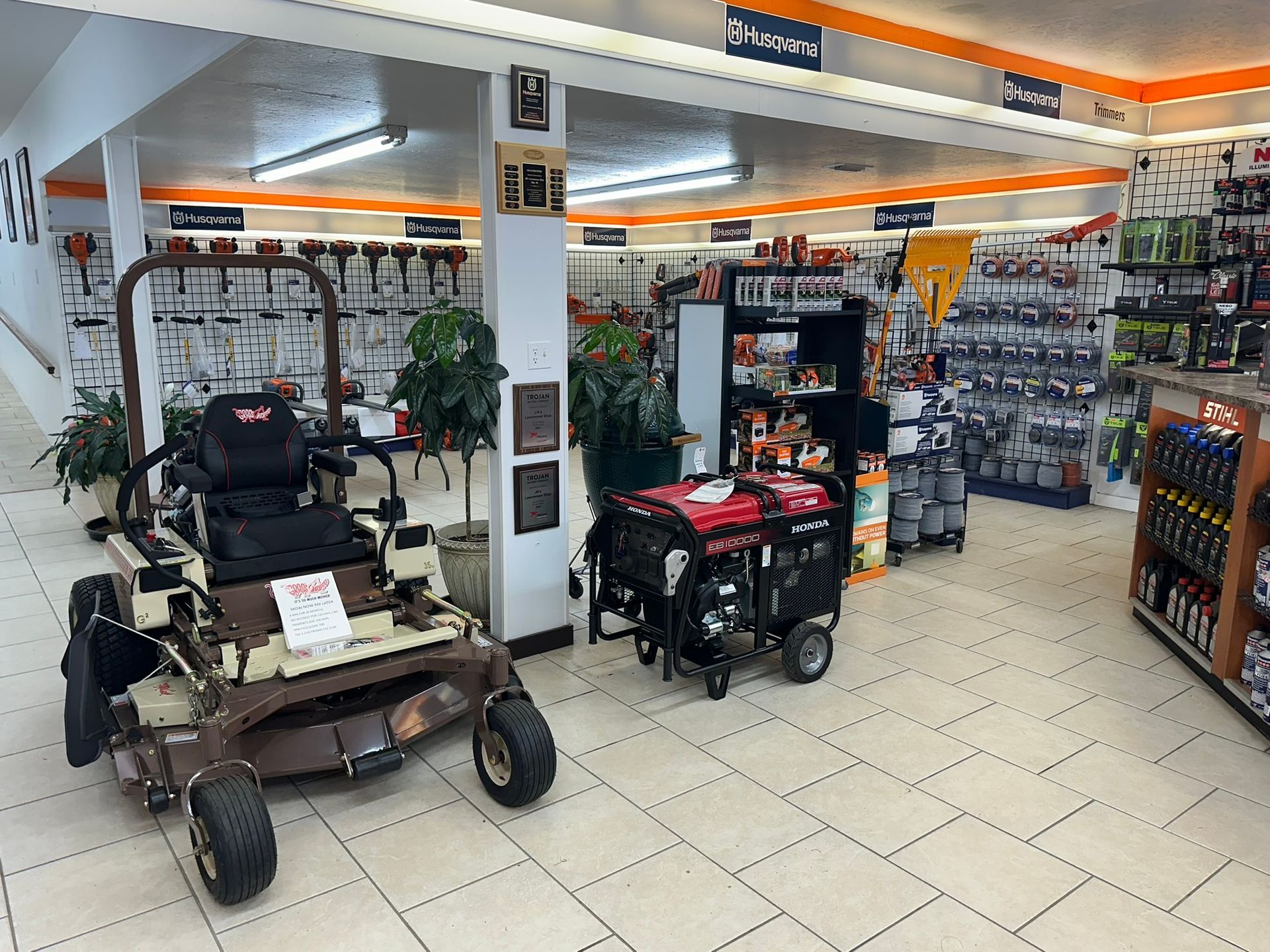A lawn mower and a generator are on display in a store.