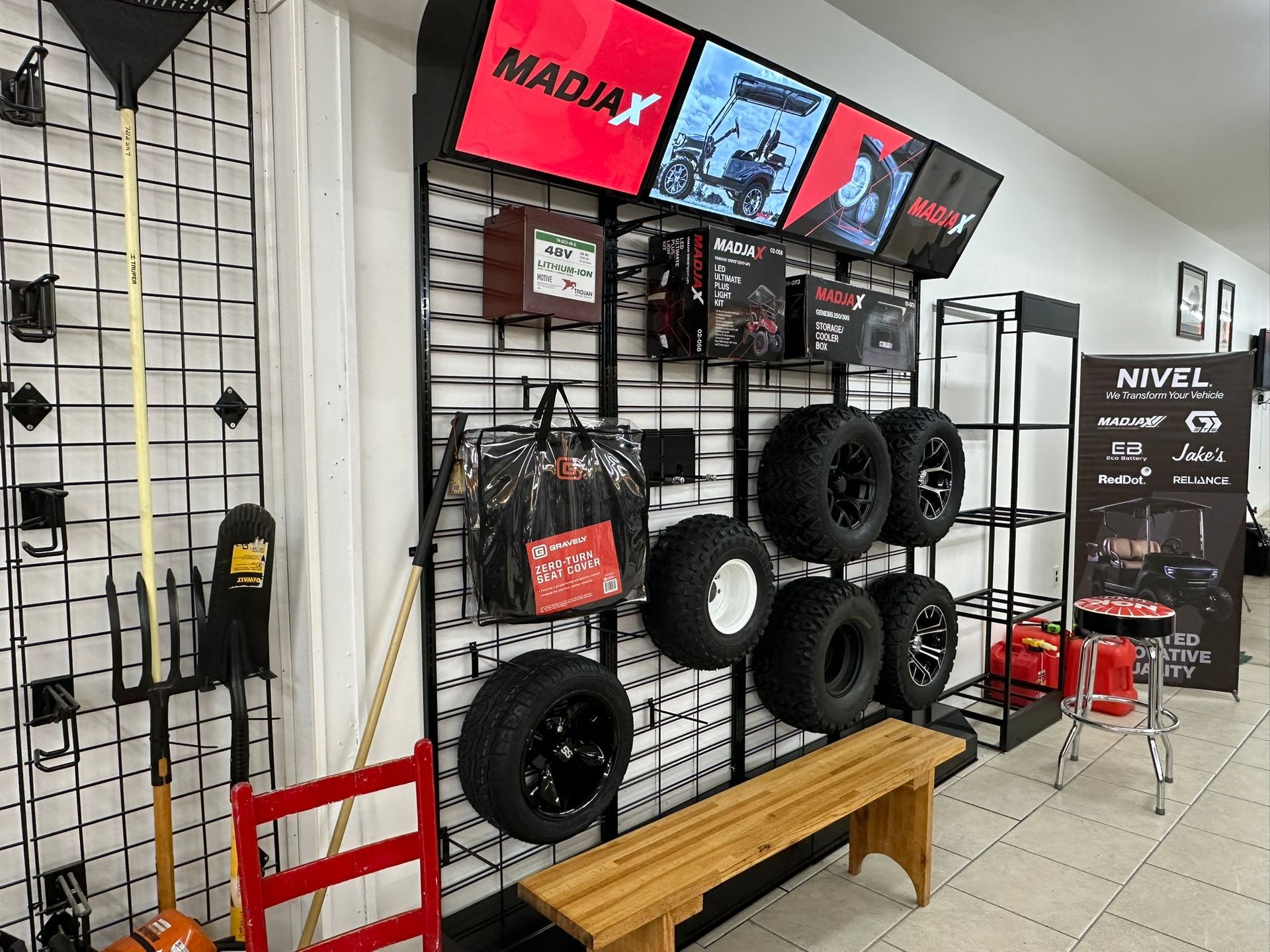 A store filled with lots of tires and a bench.