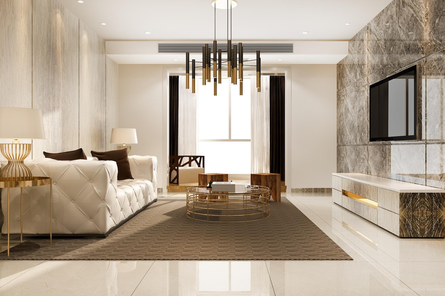 Luxurious living room with a white sofa, marble accents, and a modern chandelier.