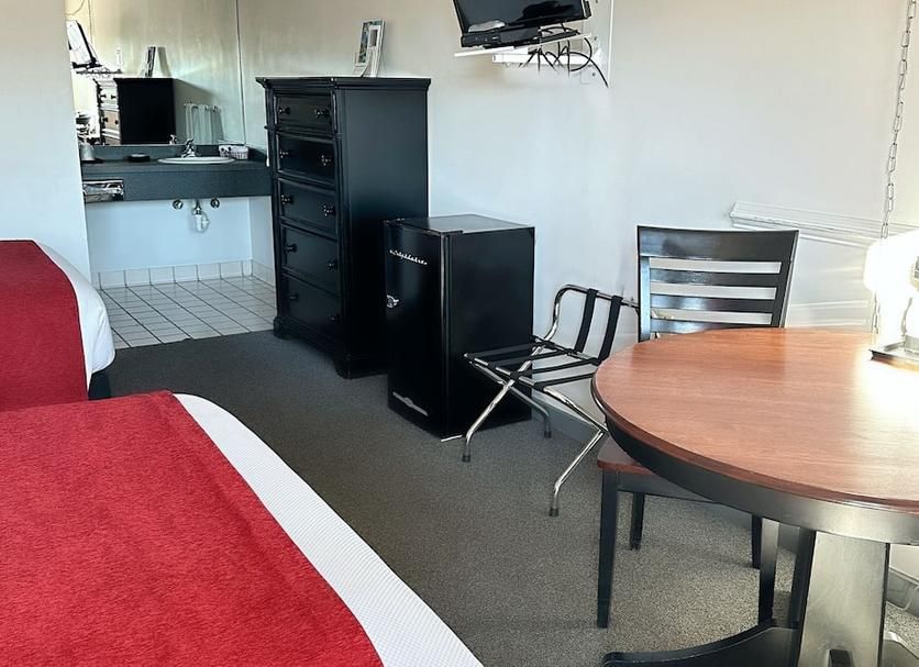 A hotel room with two beds and a table