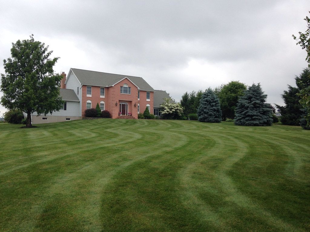 A large house with a lush green lawn in front of it