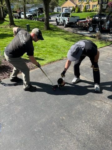 Two men are playing a game of golf in a driveway.