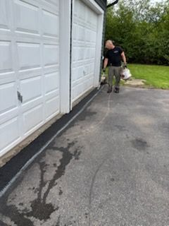 A man is standing in front of a garage door.