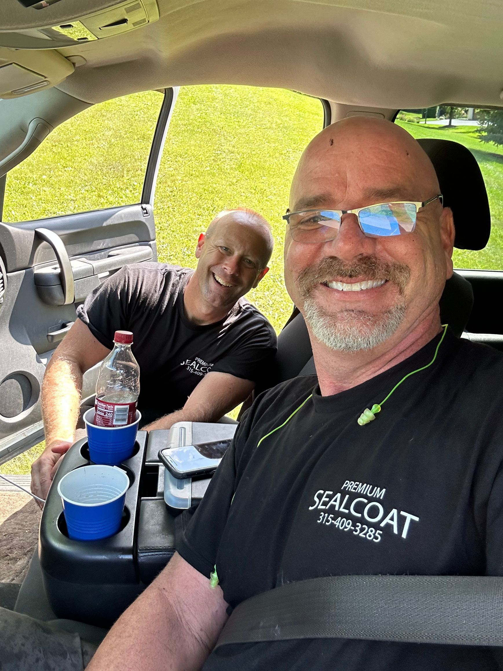 Two men are sitting in the back seat of a car.
