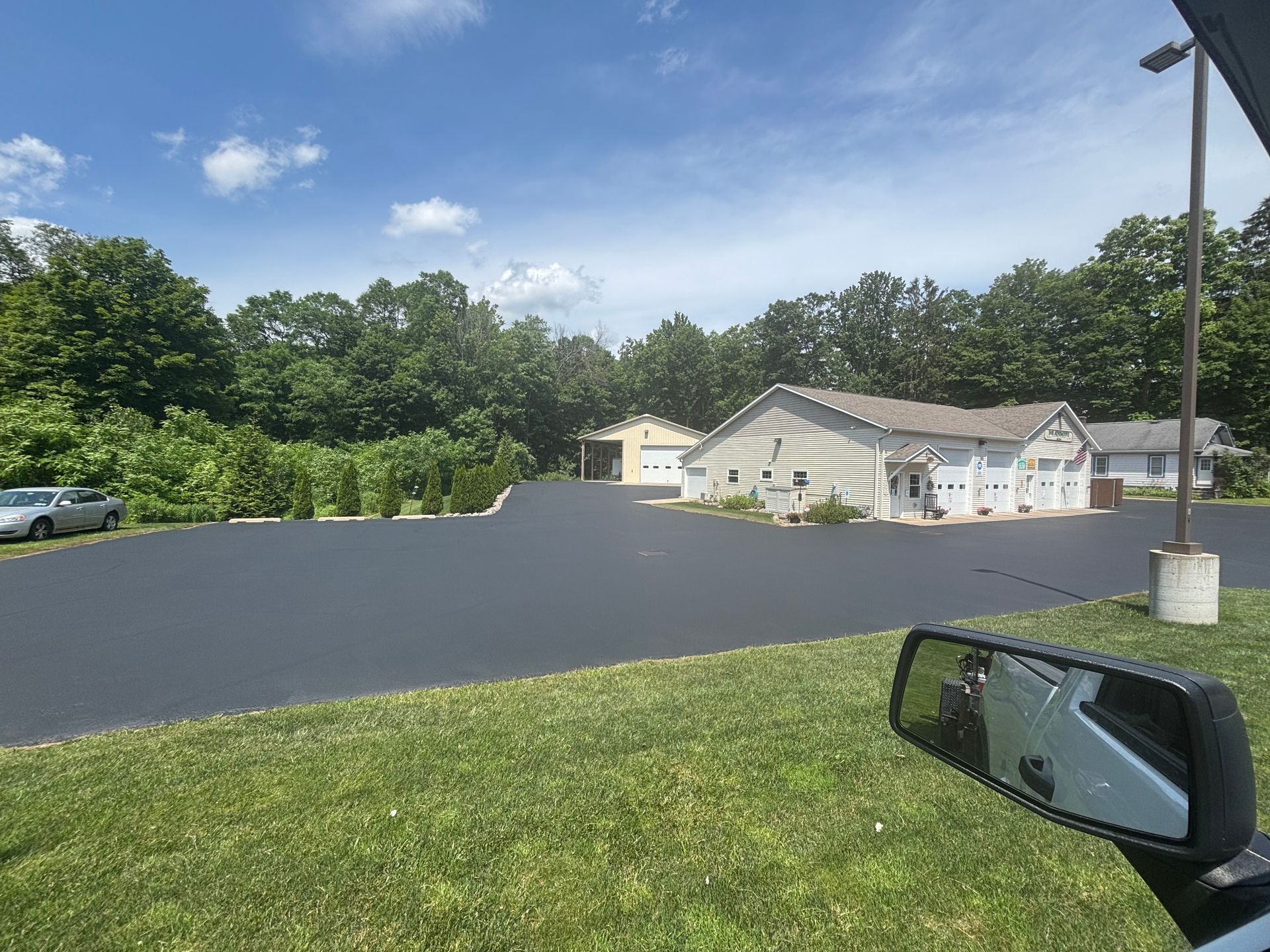 A car is parked in a parking lot in front of a house