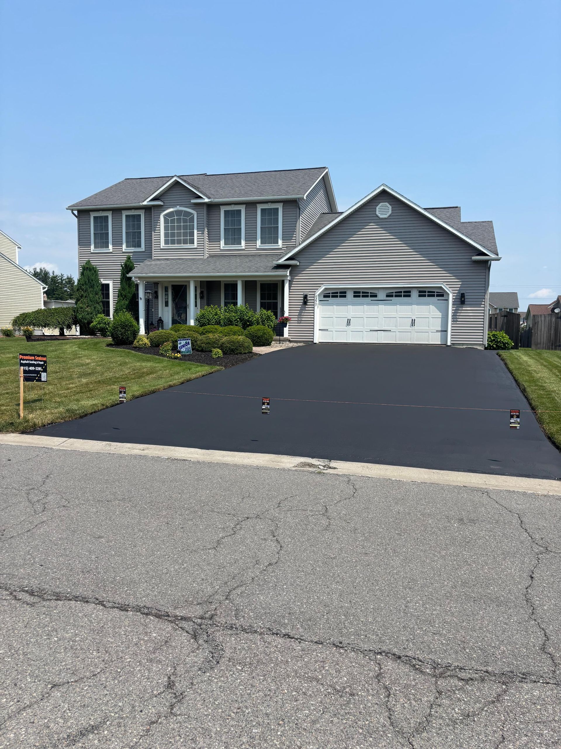 A large house with a large driveway in front of it.