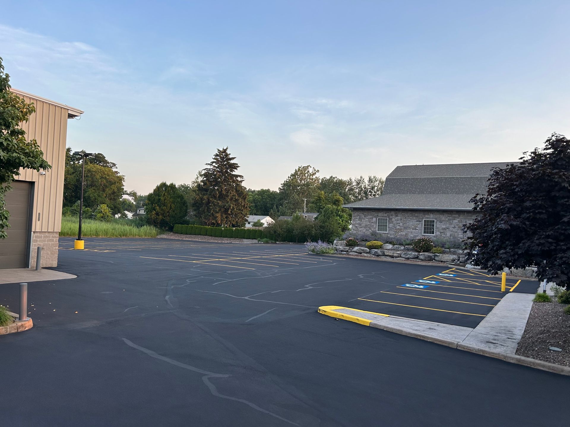 A large parking lot with a building in the background