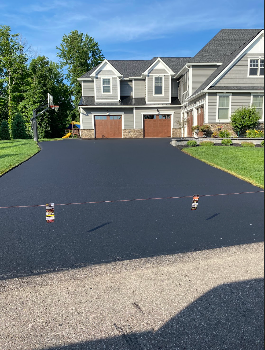 A large house with a basketball hoop in the driveway.
