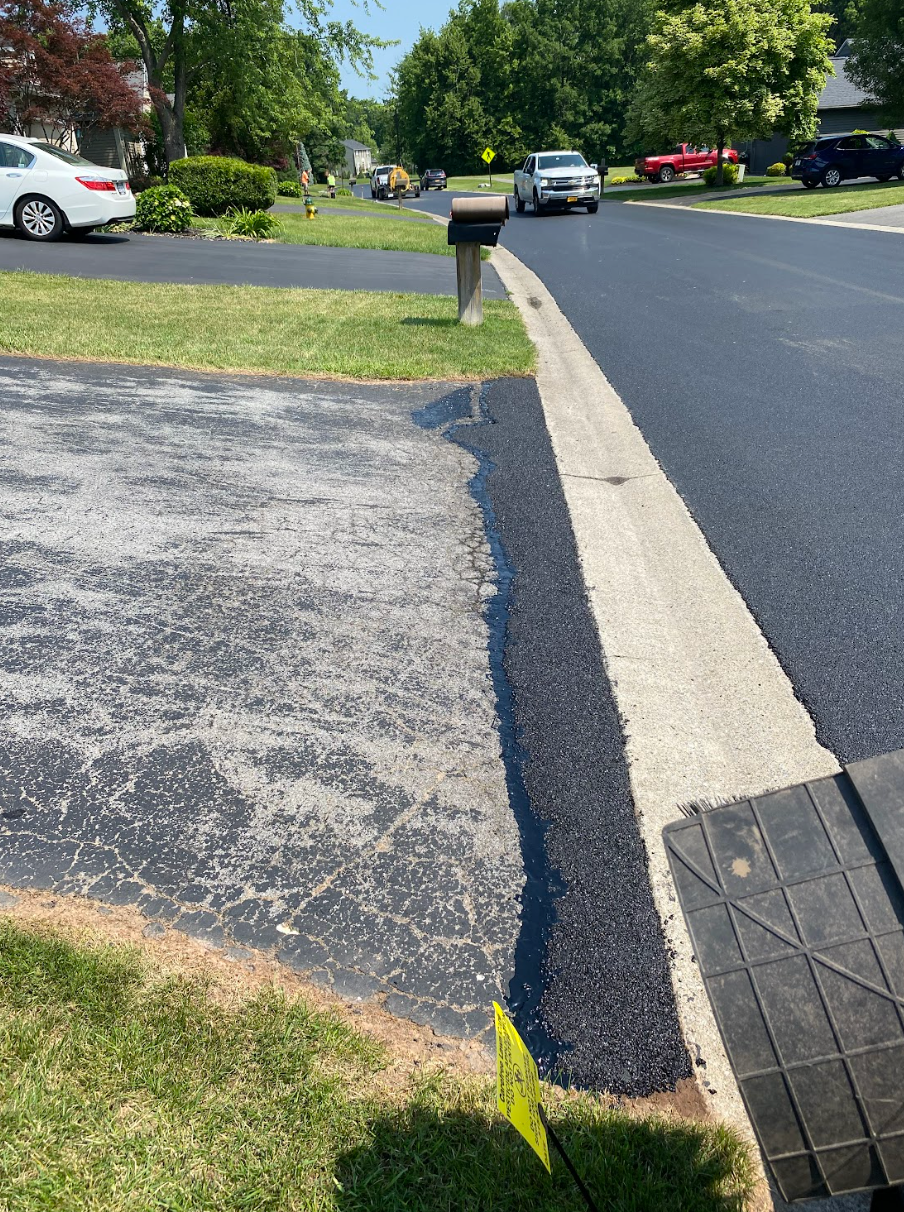 A car is parked on the side of the road next to a mailbox.