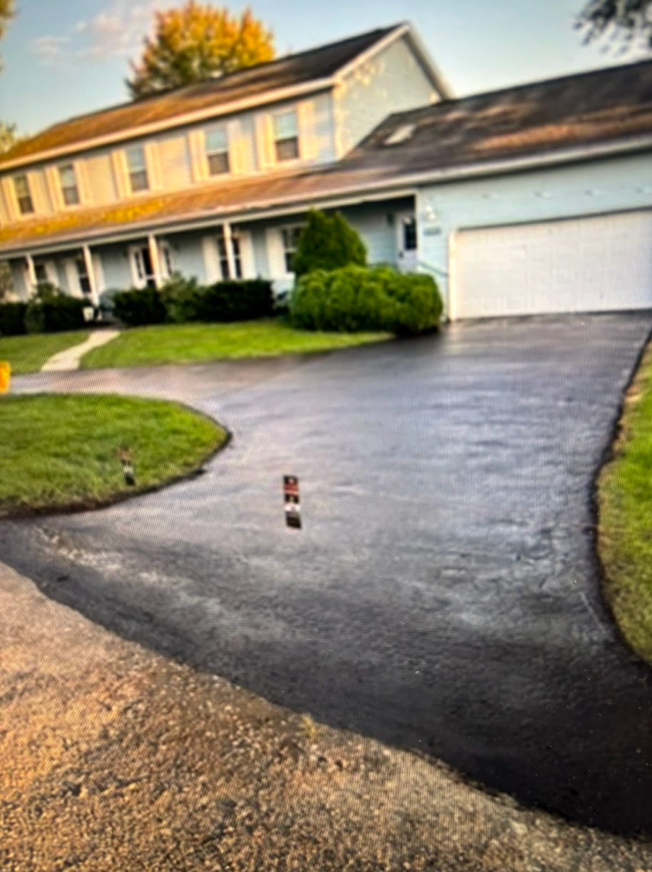 A driveway leading to a house with a garage