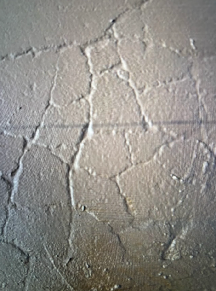 A close up of a cracked concrete surface.