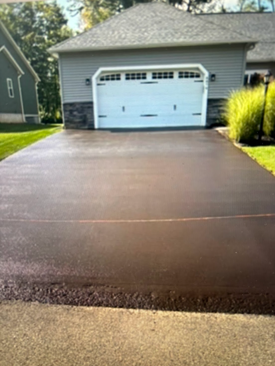 A driveway leading to a garage with a white garage door.