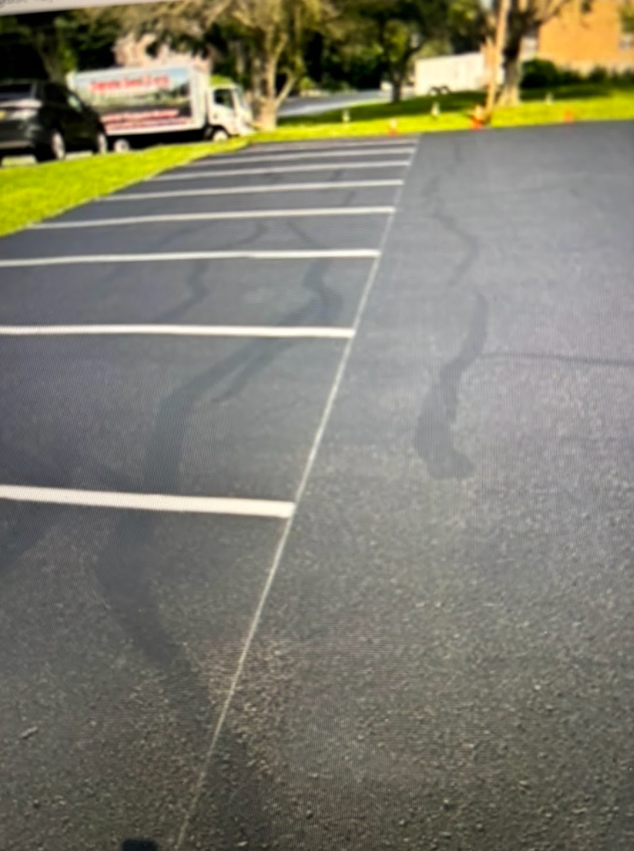 A parking lot with a truck parked in the background.