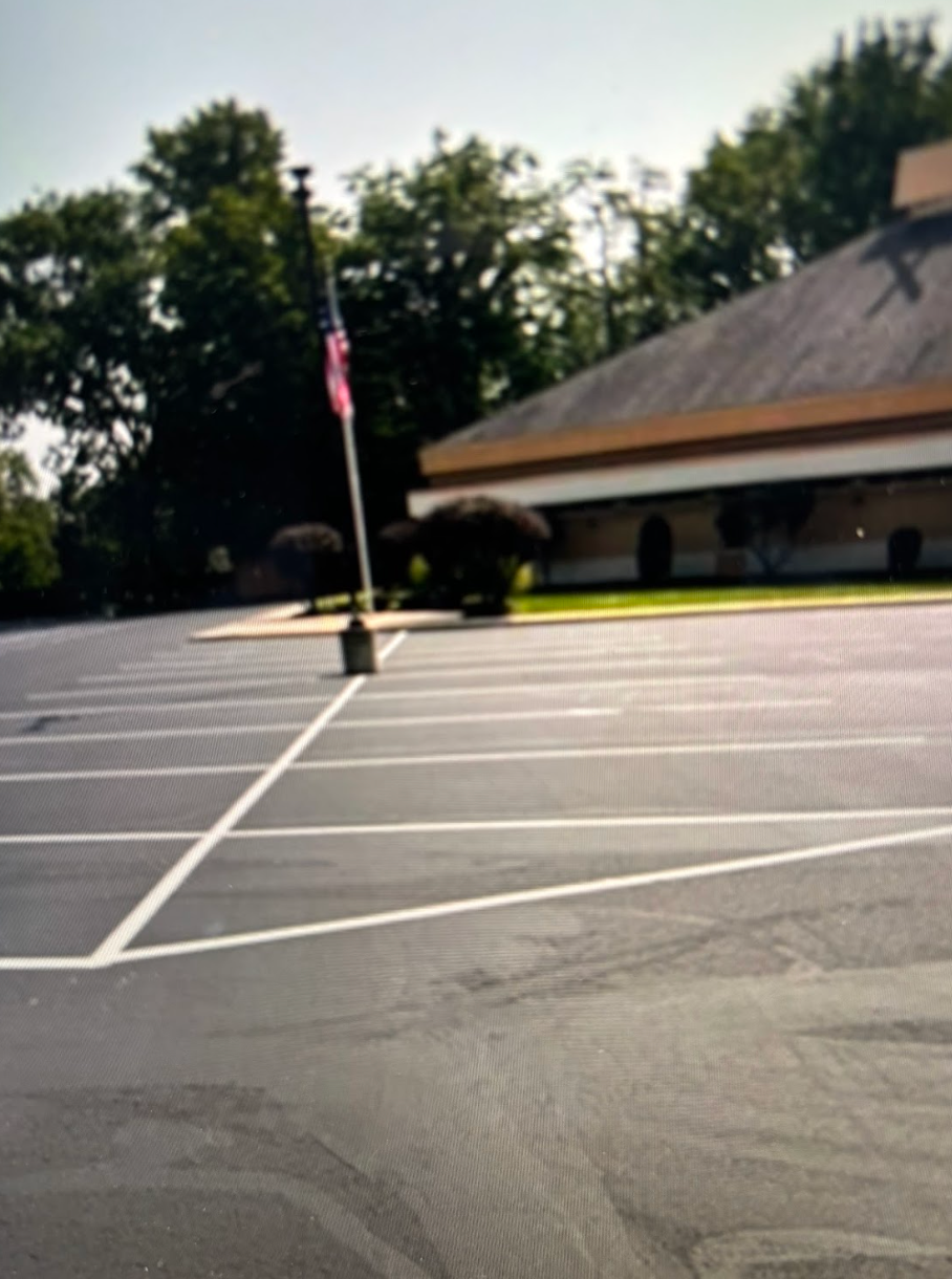 A parking lot with a building in the background