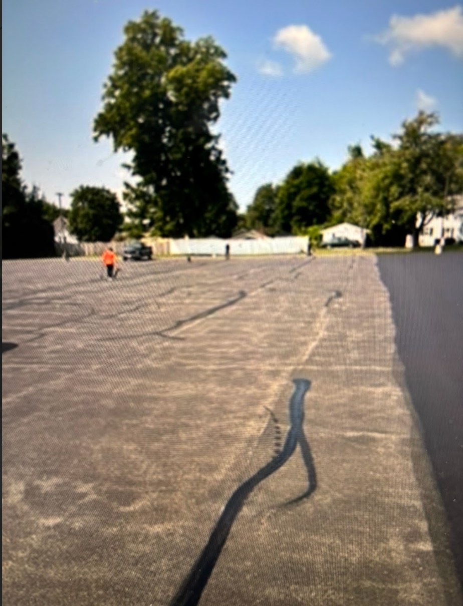 A shadow of a person is cast on a concrete surface