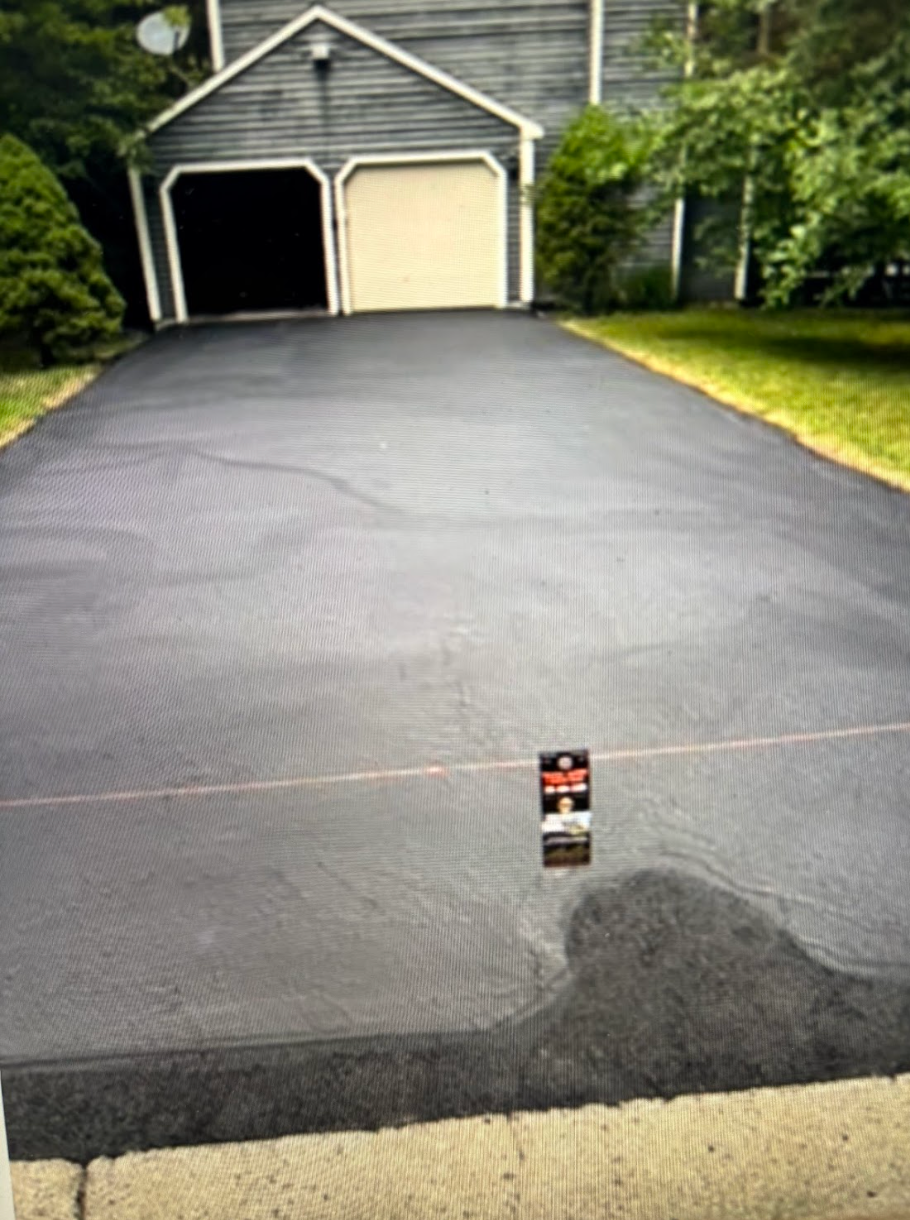 A driveway with a sign that says ' asphalt ' on it