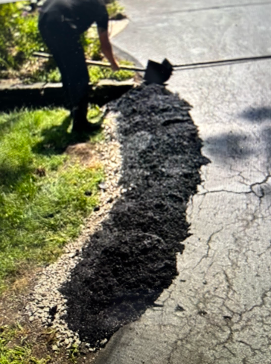 A man is digging a hole in the ground with a shovel.