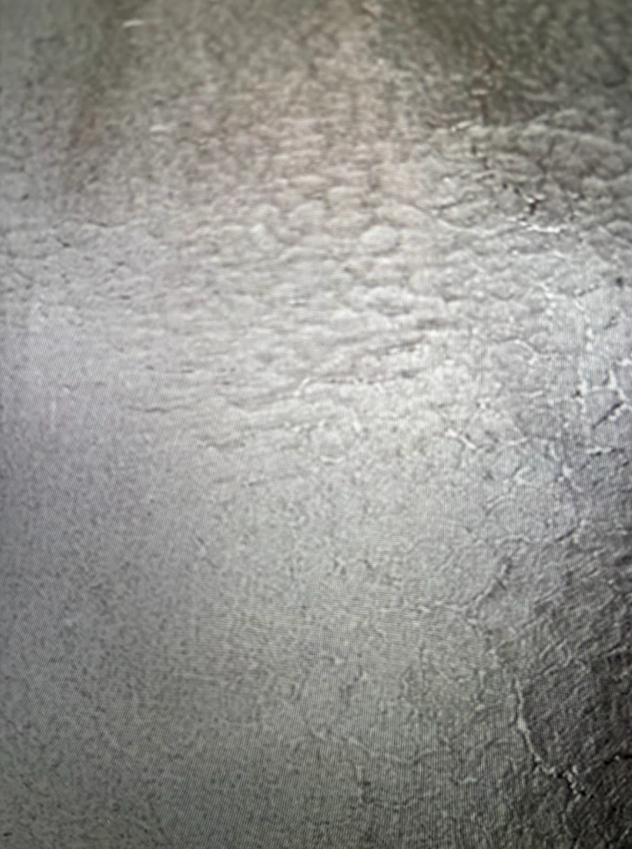 A close up of a gray surface with a texture.