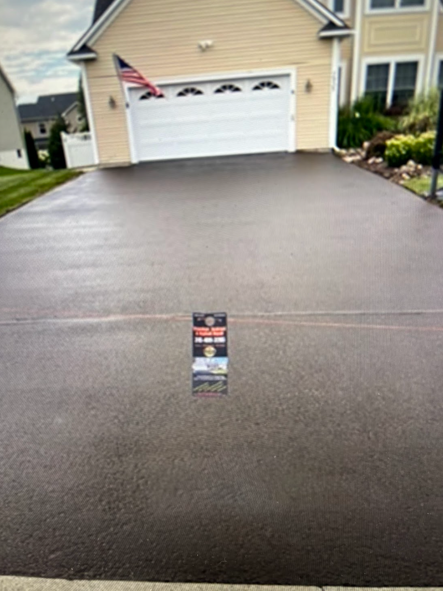 A picture of a driveway in front of a house