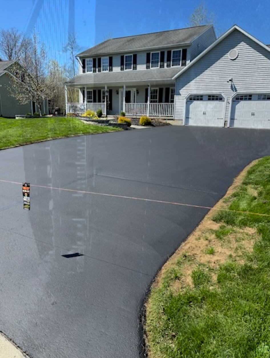A large house with a large driveway in front of it.