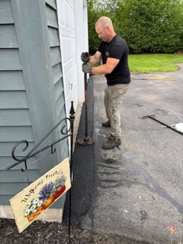A man is standing next to a sign that says welcome home.