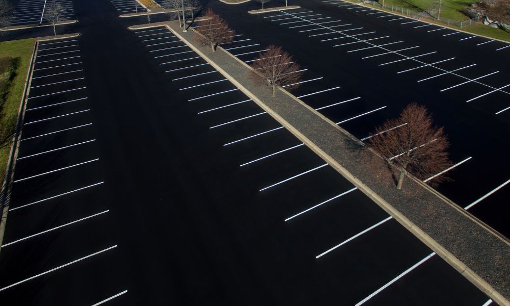 An aerial view of a parking lot with white lines on it