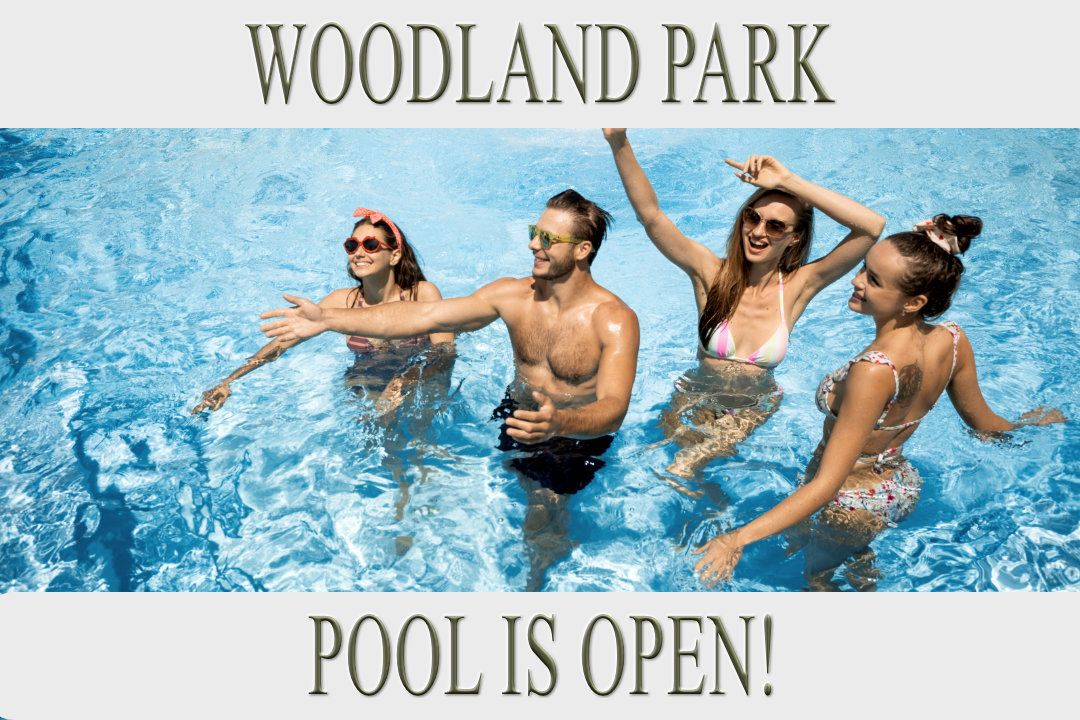A group of people are swimming in a pool at woodland park.