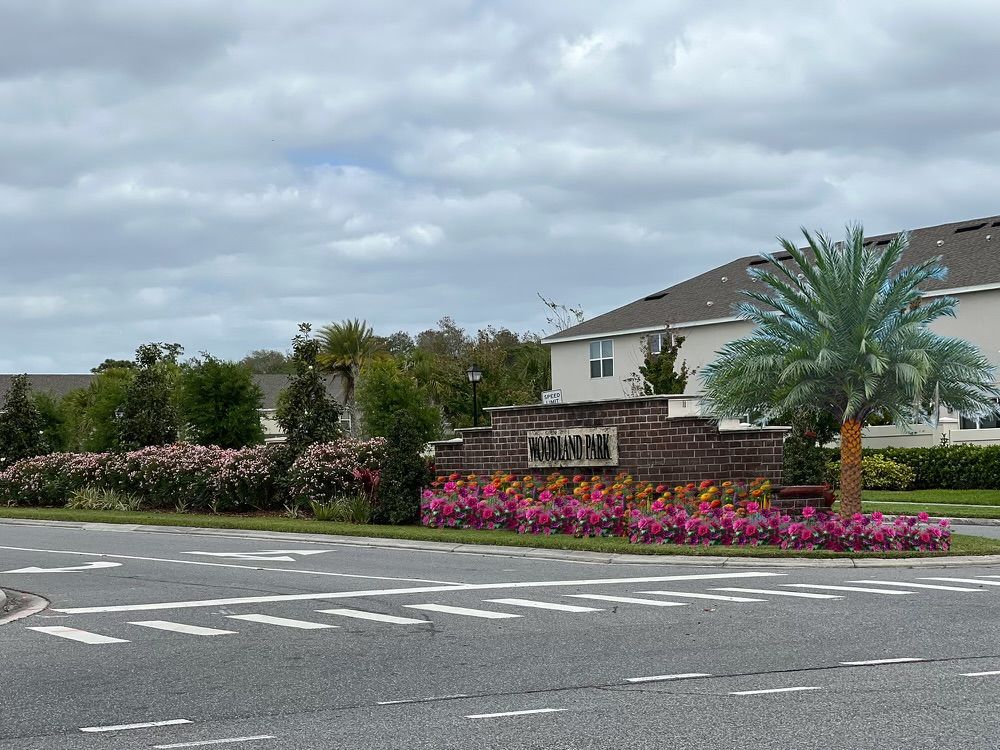 Monument sign for woodland park with rendered flowers and palm for a future upgrade