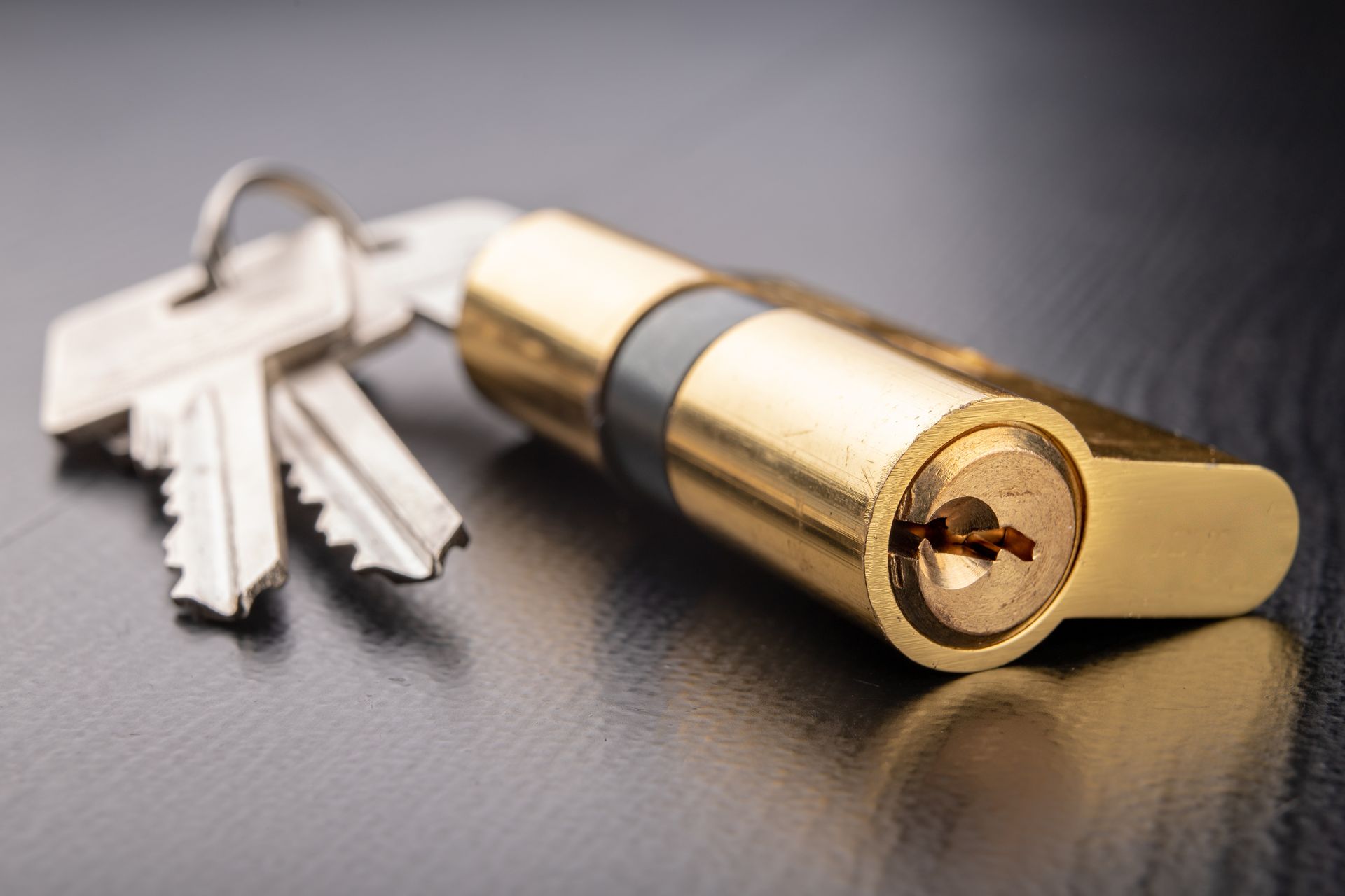 A close up of a lock and keys on a table.