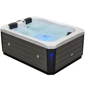 Rectangular hot tub with gray siding and white trim; bubbling water with blue lights.