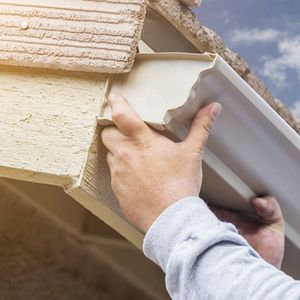 Gutter Repair — Worker Repairing a Gutter in Reno, NV