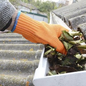 Gutter Cleaning — Worker Cleaning a Gutter in Reno, NV