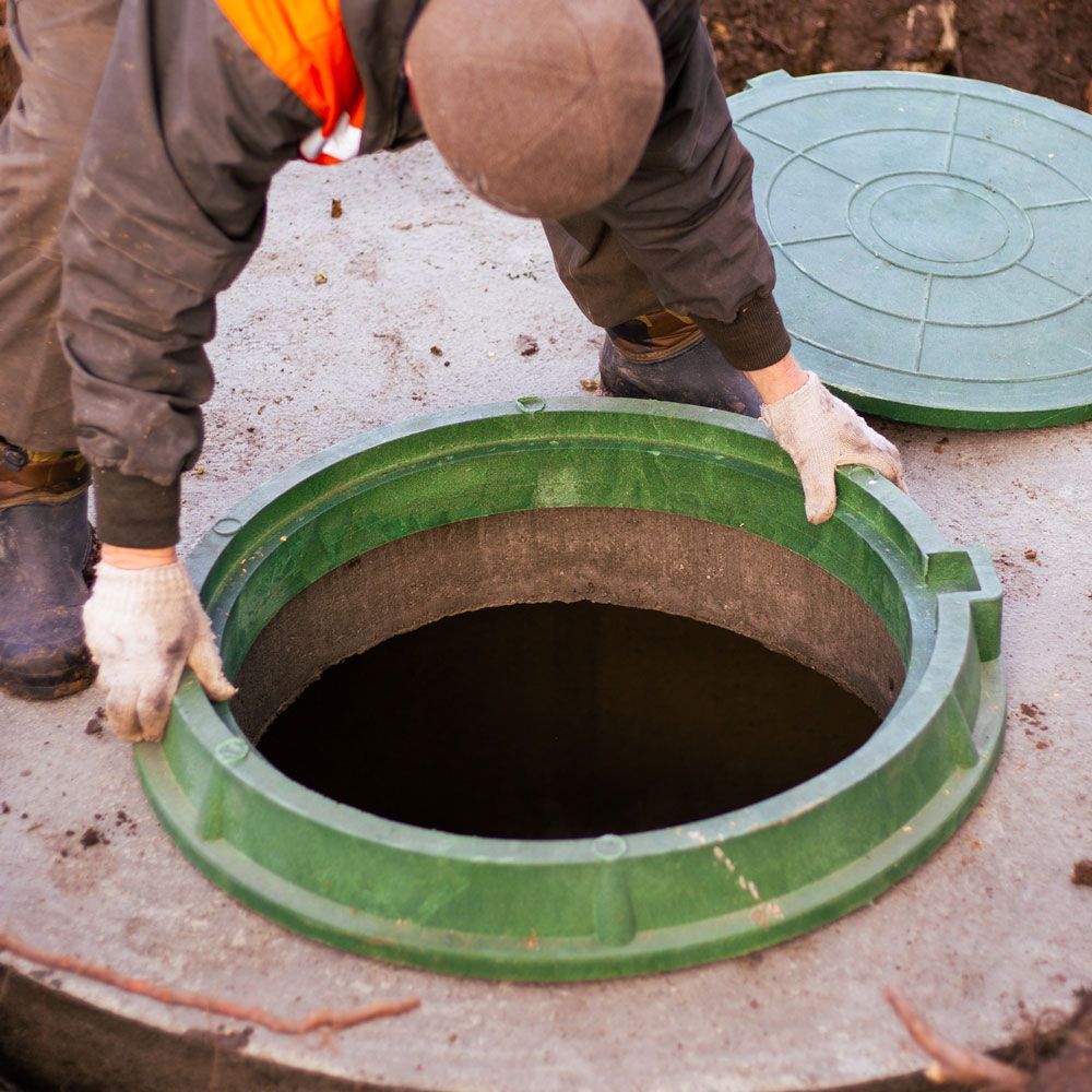 Man Checking the Septic Tank — Kalispell, MT — Ready Freddy Septic Service